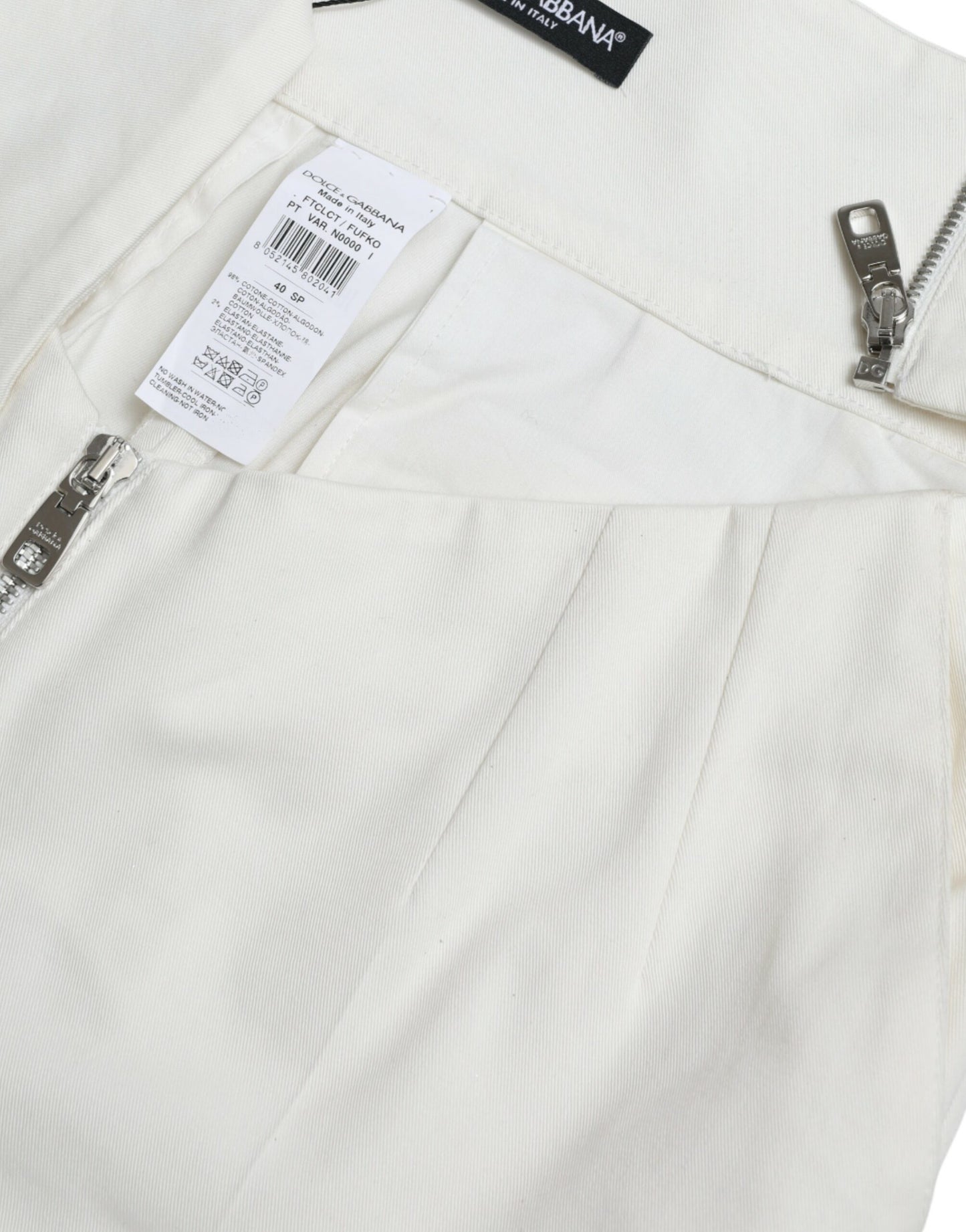 Pantalon fuselé en coton noir et blanc avec découpes à la taille